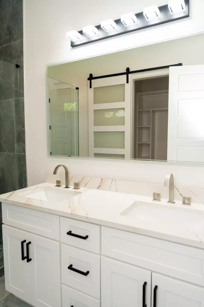 Stunning bathroom with quartz countertops on shaker style cabinet vanity that exudes modern elegance
