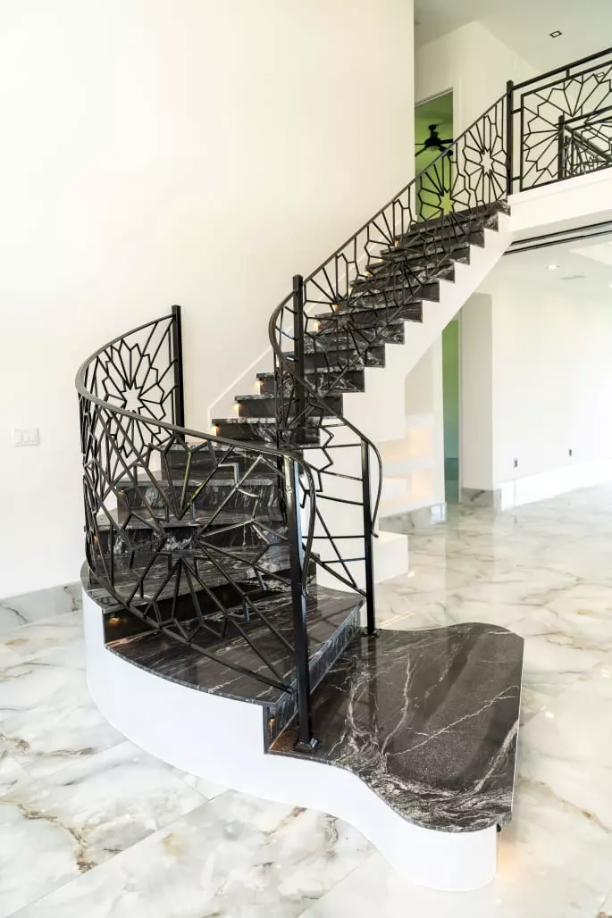 Luxurious granite stairs and 24x48 polish porcelain tiles make a stunning statement in any home